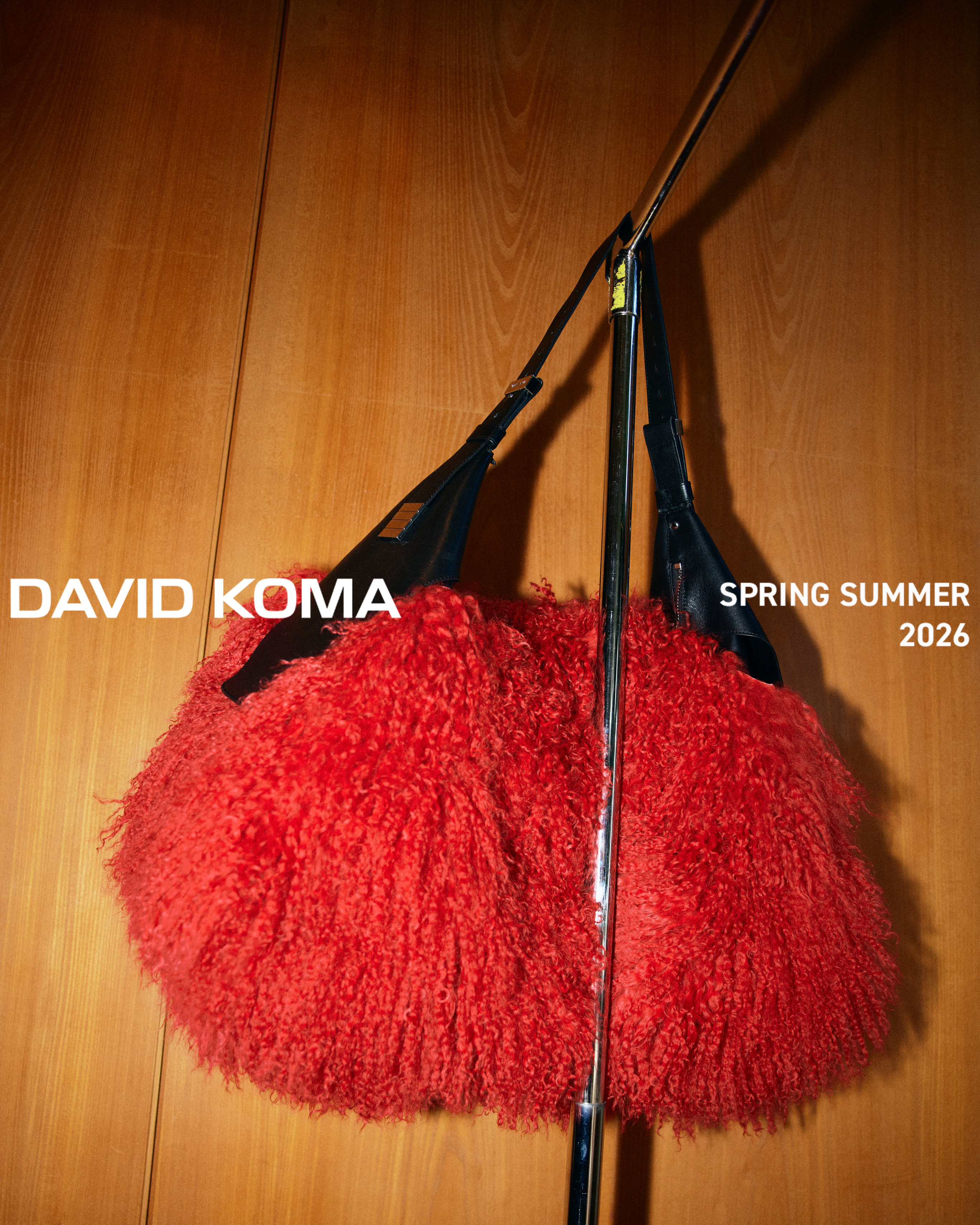 David Koma Spring Summer campaign: red feathered bag, open tailored jacket and trench coat against dark marble