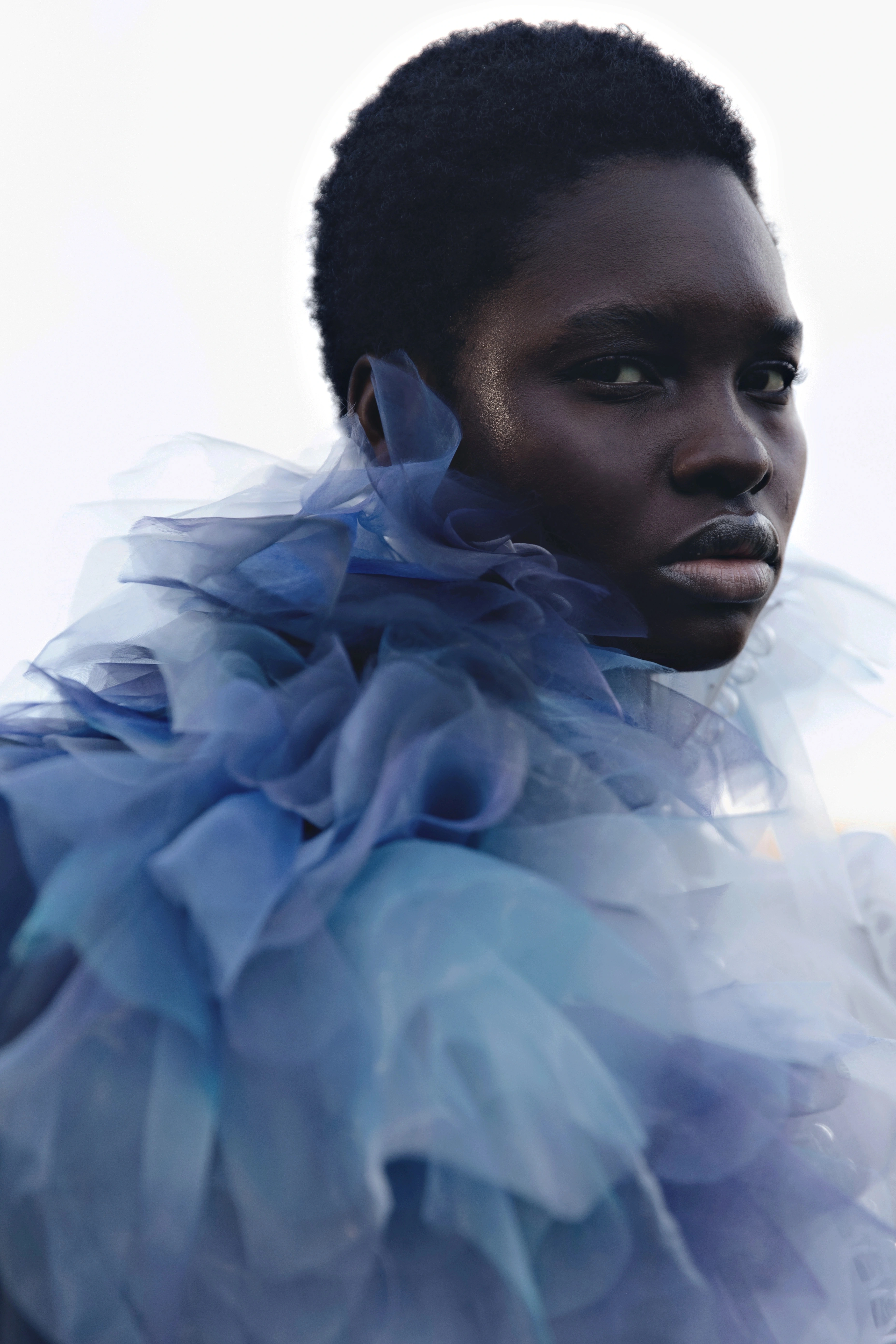 Outdoor fashion editorial: model jumping in a white tulle dress, a blue tulle collar portrait and a white fluffy top